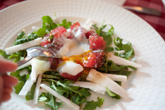 Tuna salad over arugula with poached egg